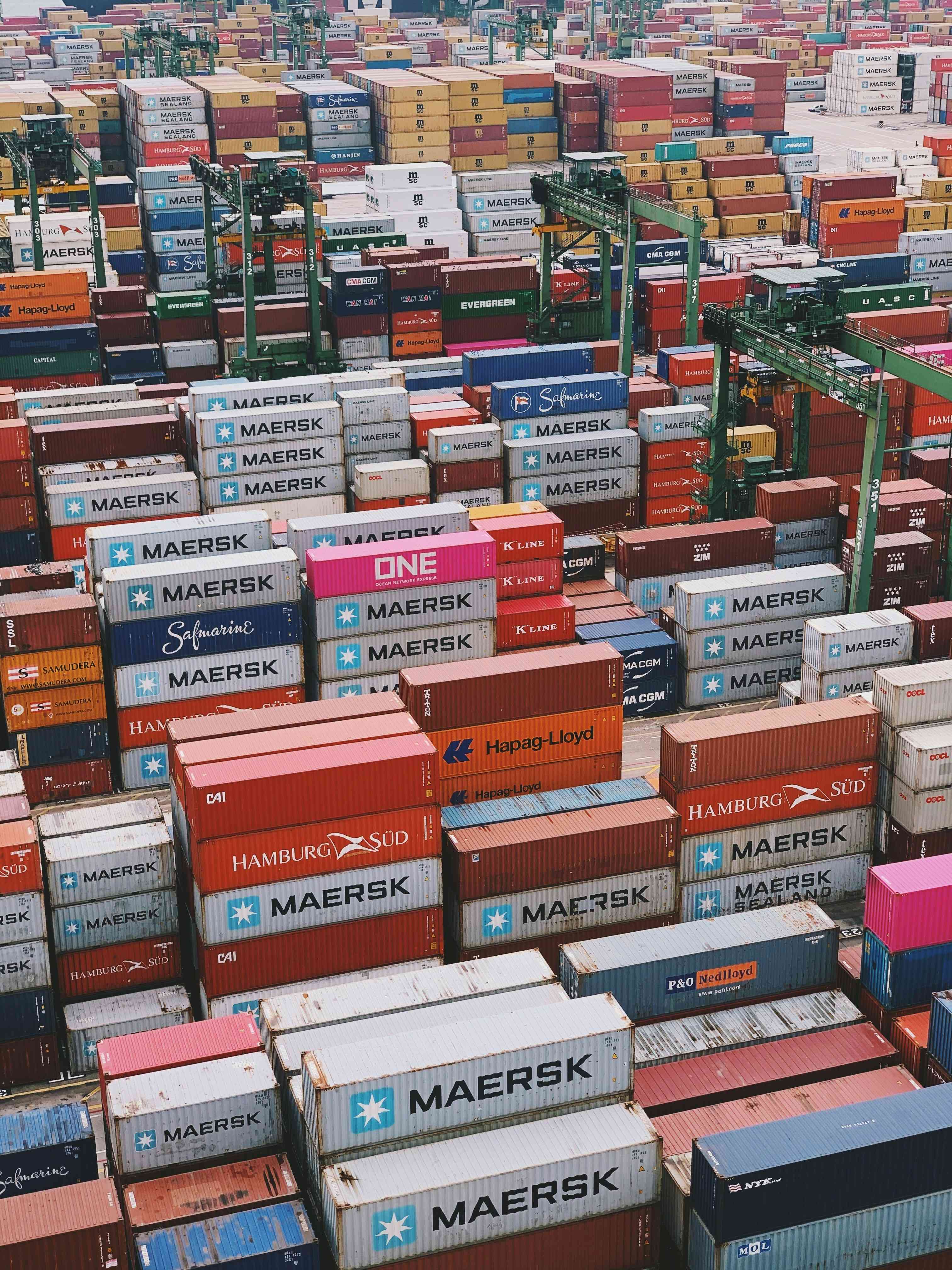Aerial view of stacked shipping containers from multiple carriers prepared for export
