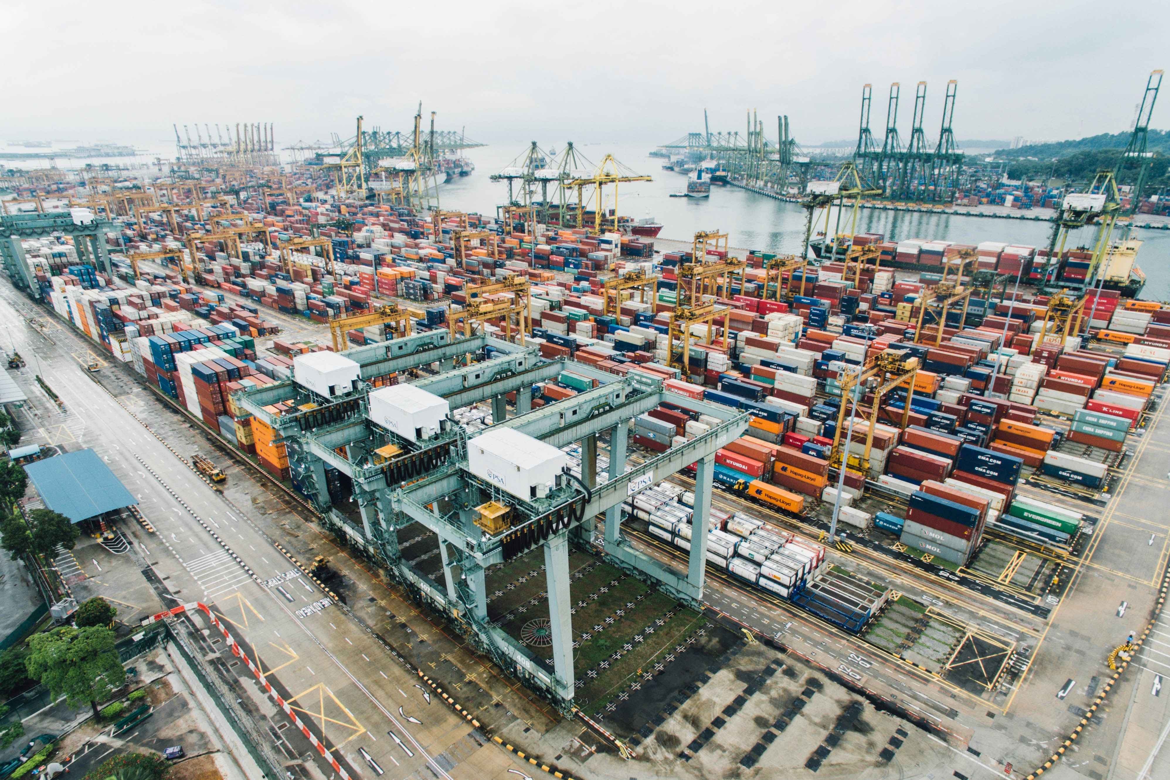 Aerial view of a container yard with port cranes serving multiple industry sectors